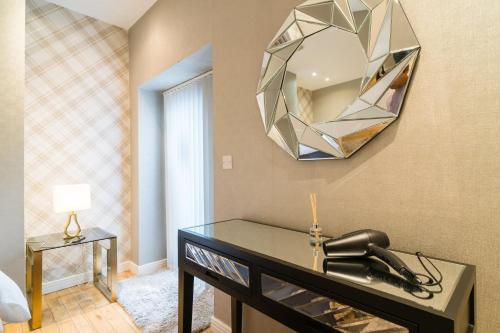 a mirror on a wall with a sink in a room at Oakfield Premier Apartments-High Speed WiFi-Smart SelfCheckIn-Central Cardiff Gem in Cardiff