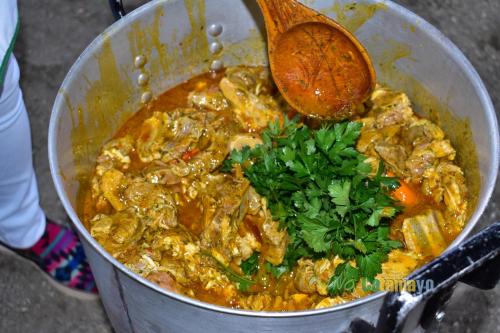 a pot of food with a wooden spoon in it at Hotel Dubái in Catamayo