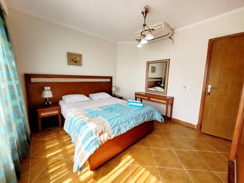 a bedroom with a large bed and a mirror at Oasis marsa alam in Marsa Alam City