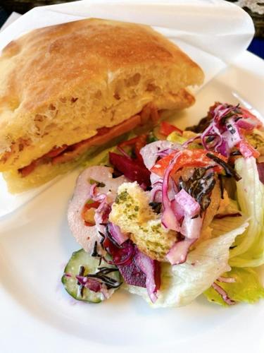 a sandwich and salad on a white plate at Pension Belnina in Hakuba