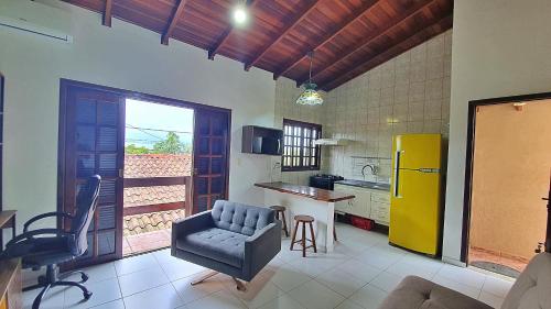 a kitchen with a couch and a chair in a room at Kitnet Superior com Vista para o Mar in São Sebastião