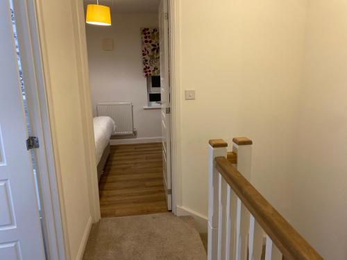a hallway with a stairway leading to a bedroom at Spacious 2 Bed House for Corporate and Family Stays in Basingstoke