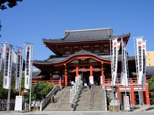 a large building with stairs in front of it at Hotel Abest Osu Kannon Ekimae Hane no Yu in Nagoya