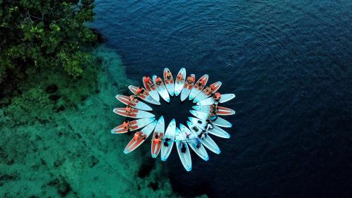 an aerial view of a group of boats in the water at The Yak Lake House - Hostal Bacalar in Bacalar