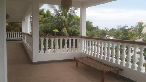 a balcony with a bench in front of a window at Tulia House Backpackers in Mombasa