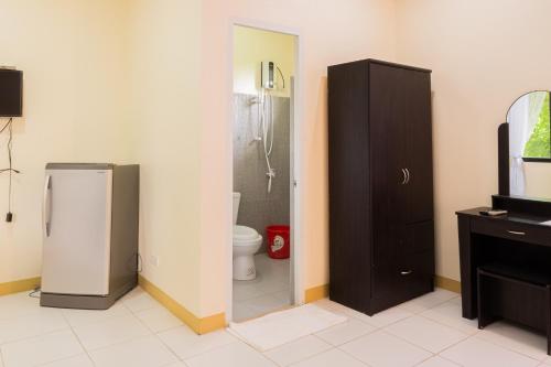a bathroom with a toilet and a sink and a refrigerator at Almira Diving Resort- Panglao in Panglao