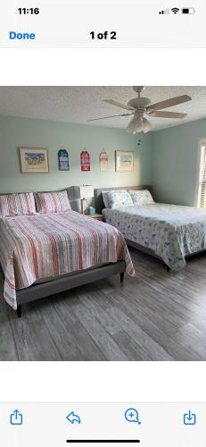 a bedroom with two beds and a ceiling at Sea Club Condo #37 in Clearwater Beach