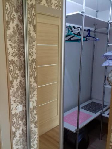a closet with a mirror next to a door at Аренда квартиры город Рудный in Rudny