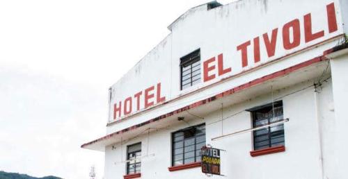 a hotel sign on the top of a building at Hotel Tivoli in San Cristóbal de Las Casas
