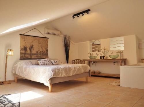 a bedroom with a bed and a table in a room at Villa Sunset in La Saline les Bains