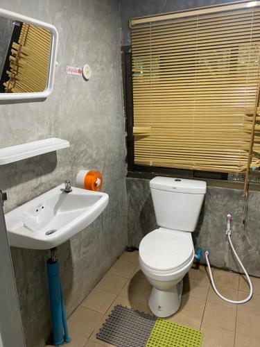 a bathroom with a toilet and a sink at Khao Kho Copter Hill in Ban Khao Ya Nua