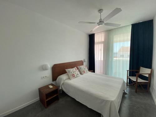 福爾內利斯的住宿－Riera Rossello 3，一间卧室配有一张床和吊扇