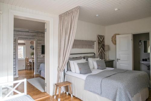 a bedroom with a large bed and a living room at Hapsal Dietrich apartemendid in Haapsalu