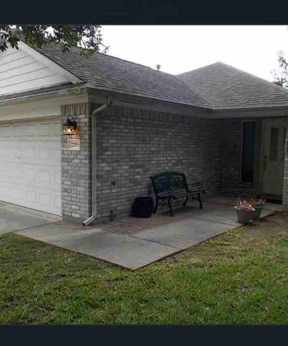 a brick house with a bench on a patio at Cozy Pet-Friendly Home- Huge Spring Discounts in Spring