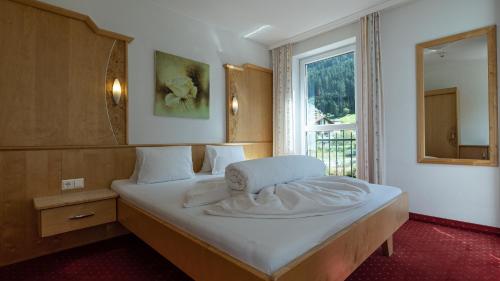 Ένα ή περισσότερα κρεβάτια σε δωμάτιο στο Alpin-Apart