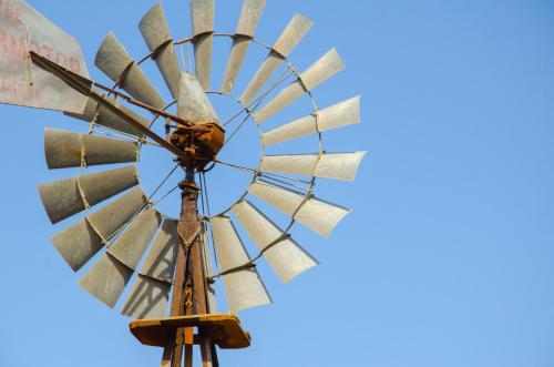 an old windmill against a blue sky at Desert Dew Guest House in Hutchinson