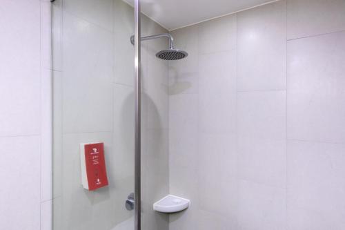 a shower with a red sign in a bathroom at Red Planet Bangkok Surawong in Bangkok