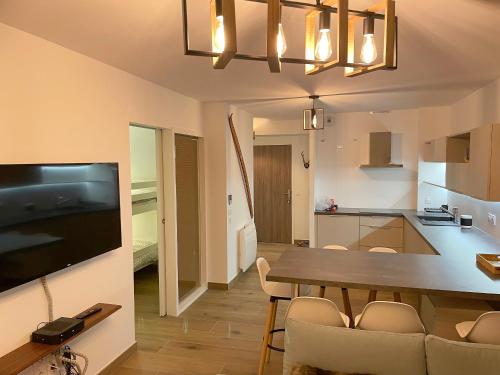 una cucina e una sala da pranzo con tavolo e sedie di L' Etoile du Pic a La Mongie