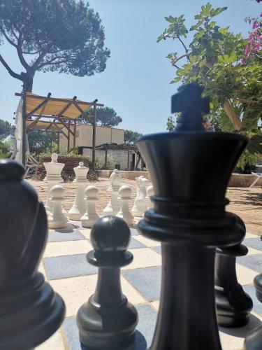 a chess board with white chess pieces on it at Residence Villa Olivia in Ischia