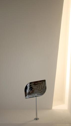a black chair in a room with a white wall at The King George Village Boutique Living in Għargħur