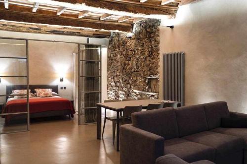 a room with a bed and a couch and a table at Orta Paradise 6 in Orta San Giulio