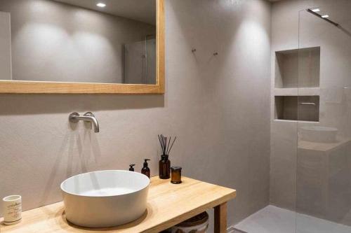 a bathroom with a large white sink and a shower at Orta Paradise 6 in Orta San Giulio