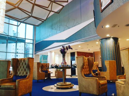 a waiting room with chairs and a table at Costa Del Sol Hotel by Arabian Link in Kuwait