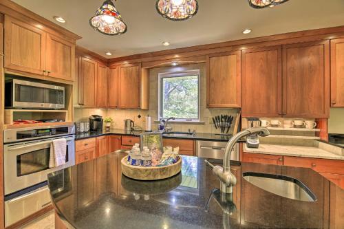 a kitchen with wooden cabinets and a large island at Updated Ranch-Style Home with Scenic Deck, Pond in Kingsport