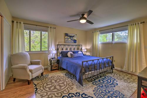 a bedroom with a bed and a chair and windows at Updated Ranch-Style Home with Scenic Deck, Pond in Kingsport