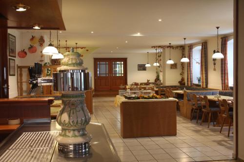 un restaurante con comedor con mesas y sillas en Landgasthof Ostermair, en Petershausen