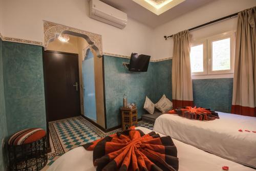 Postel nebo postele na pokoji v ubytování Riad Les Oliviers & Spa