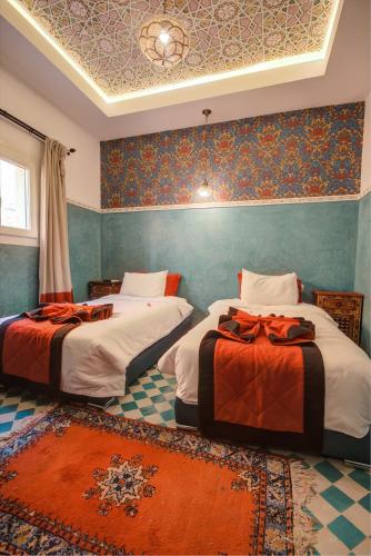 Postel nebo postele na pokoji v ubytování Riad Les Oliviers & Spa