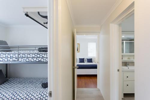 A bunk bed or bunk beds in a room at Blue Bay Beach Stay - Mandurah
