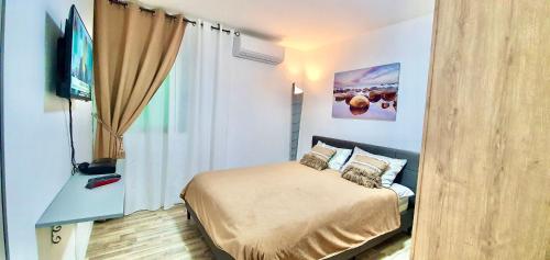 a bedroom with a bed and a flat screen tv at VIP suits Eilat in Eilat