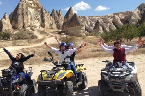 a group of people riding on atvs in the desert at Deep Cave House in Urgup