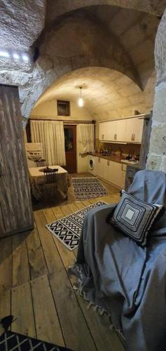 a large room with a kitchen and a living room at Deep Cave House in Urgup