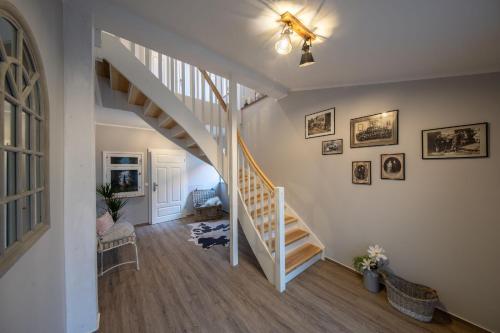 a hallway with a staircase in a home at Sternadelshof in Großgrabe