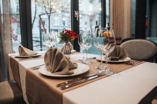 a table with wine glasses and napkins on it at Boutique Hotel Townhouse 27 in Belgrade