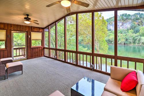 a living room with a view of a river at Private Riverfront Home on the White River! in Norfork