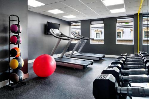 a gym with tread machines and a red ball in a room at SENS Høtel in Montréal