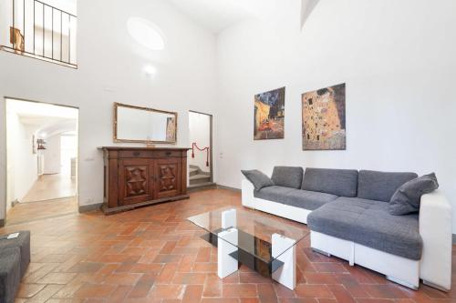 a living room with a couch and a table at Pontevecchio Luxury Suite AMAZING LOCATION - hosted by Sweetstay in Florence