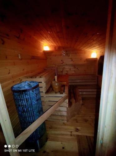 a inside of a wooden sauna with a bucket at Bezdroża Mazurskie in Mrągowo