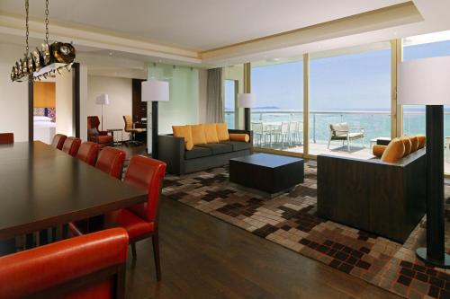 a living room with a couch and a table and chairs at Radisson Blu Hotel, Conakry in Conakry