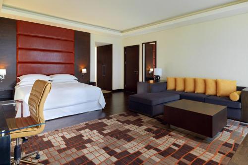a hotel room with a bed and a couch at Radisson Blu Hotel, Conakry in Conakry