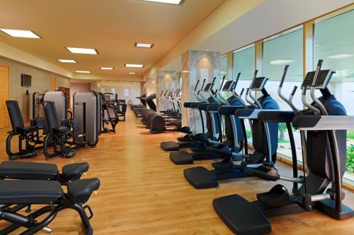 a gym with a row of treadms and pilates equipment at Radisson Blu Hotel, Conakry in Conakry