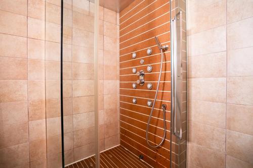 a shower with a glass door in a bathroom at Villa D'Anzi B&B in Ginosa