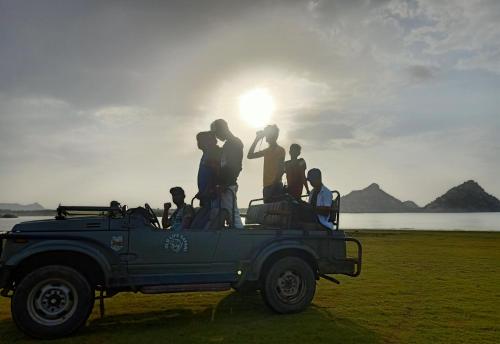a group of people standing on the back of a jeep at Jawai Bagpackers Hostel in Sheoganj