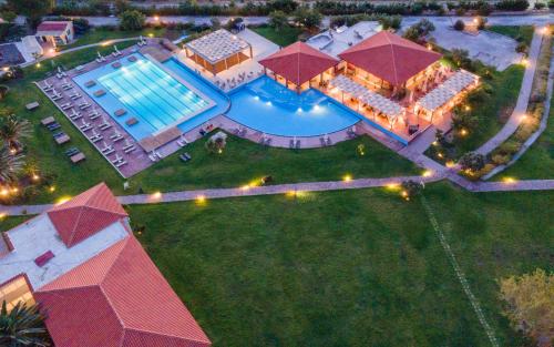an aerial view of a mansion with a swimming pool at Aeolian Village Beach Resort in Skala Eresou