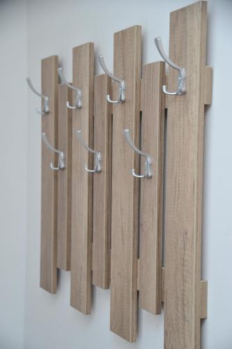 a row of wooden hooks hanging on a wall at Apartmani Krstojević Kopaonik in Kopaonik