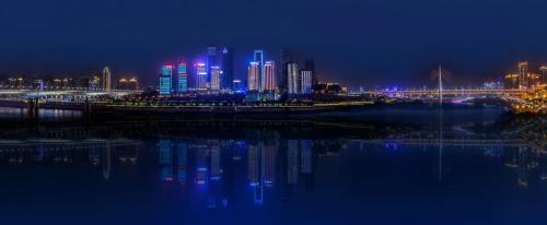 a city lit up at night next to a body of water at Regent Chongqing - Complimentary 1st round mini bar daily in Chongqing